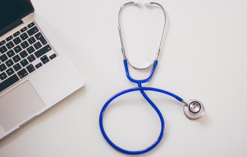 Stethoscope and laptop on physician’s desk