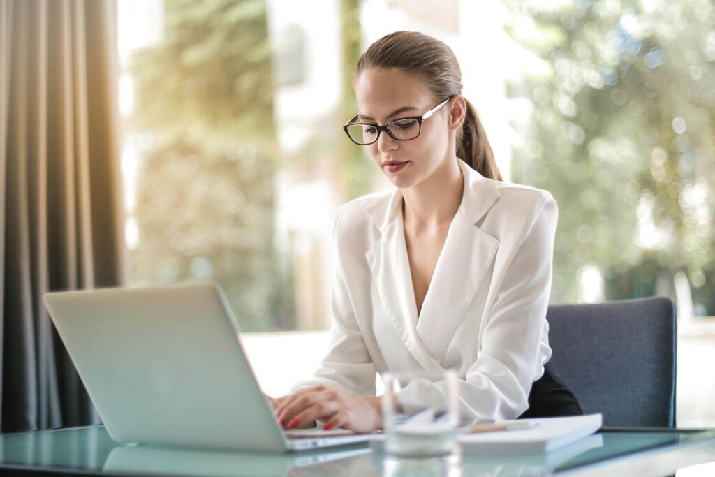 A woman typing on a laptop